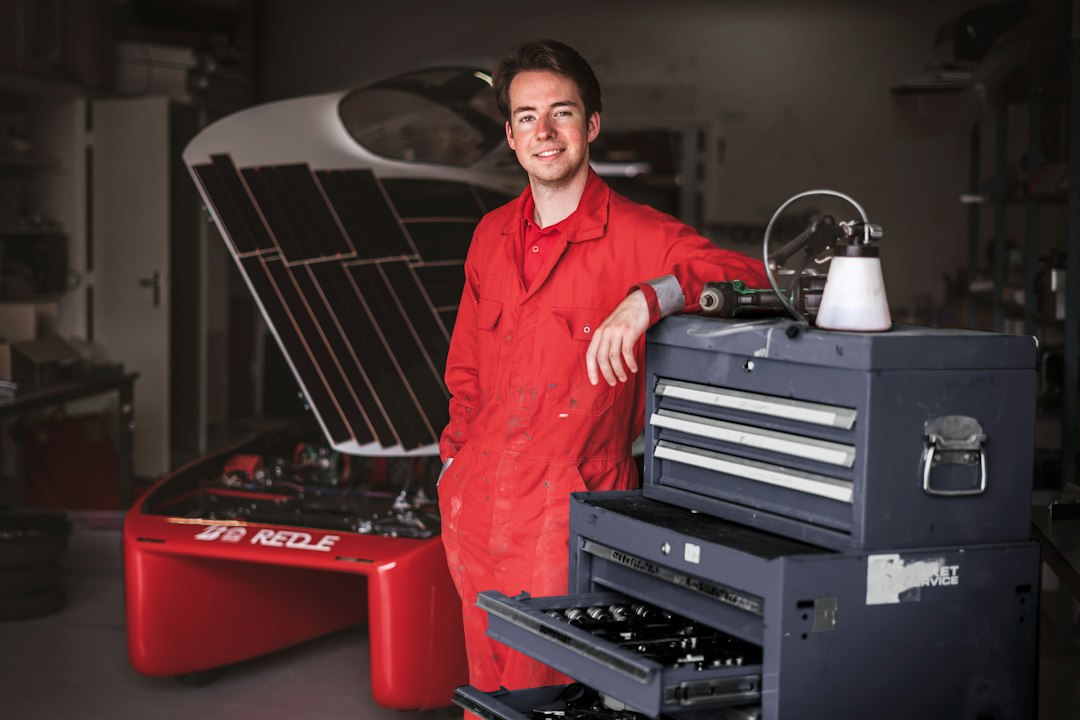 Technician with professional automotive tools in garage